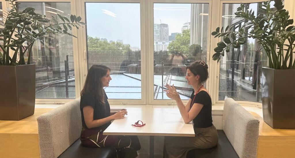 An image of our Chief Growth Officer, Tiffany Smyly, in discussion with our Director of Programmes, Olivia Platman.